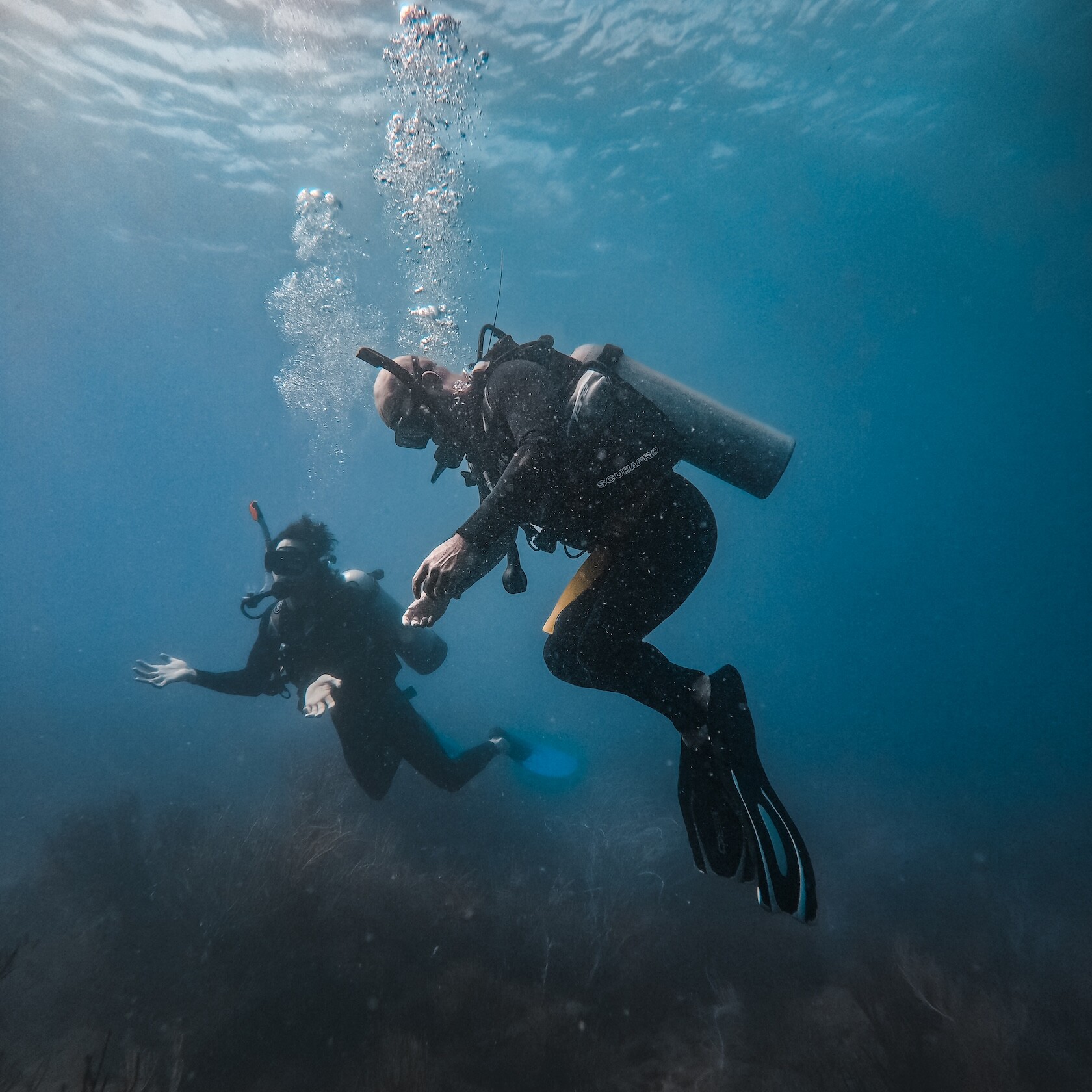 divers breathing underwater uai