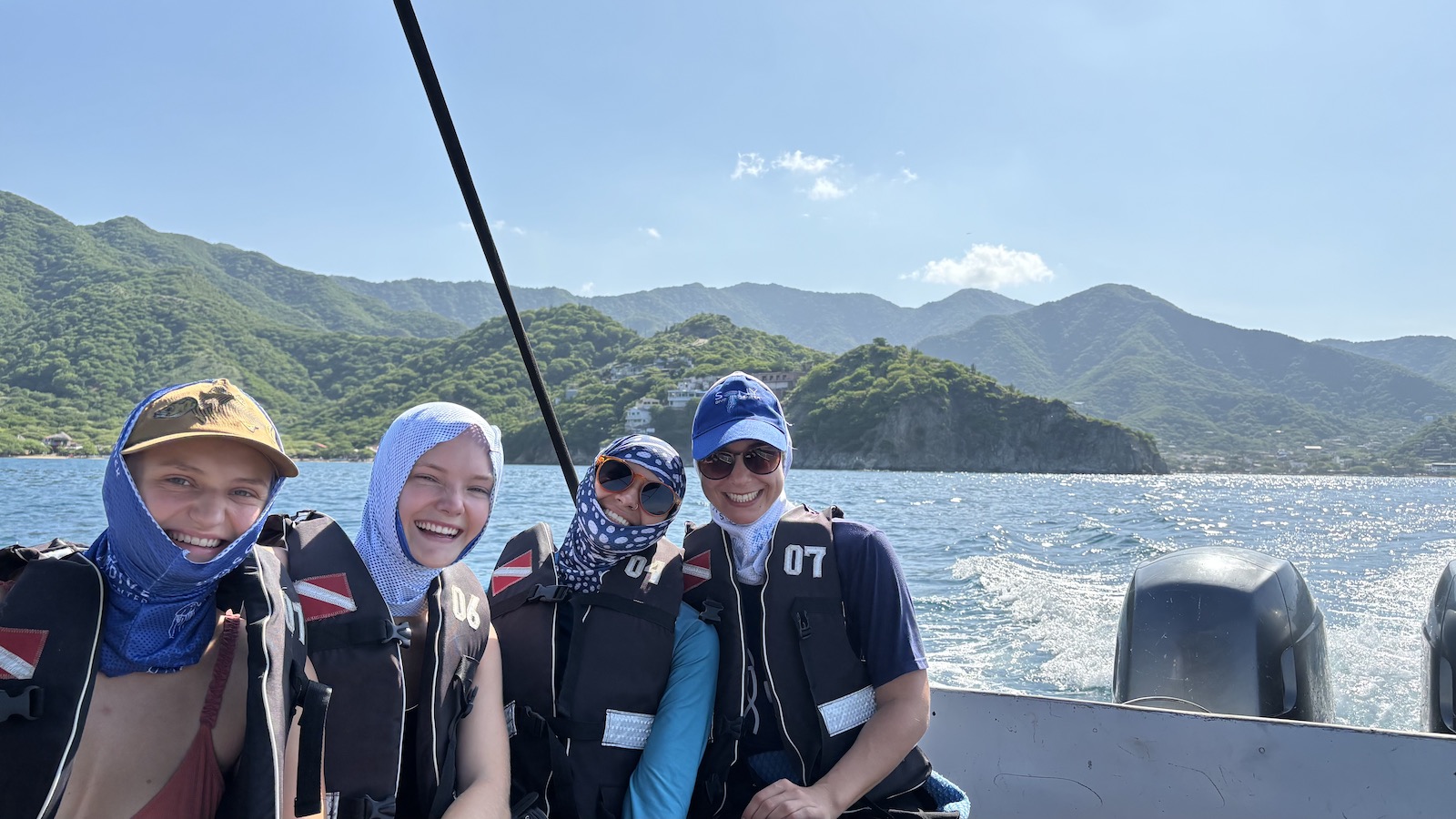 PADI certified gilrs scuba diving in Taryona National Park.